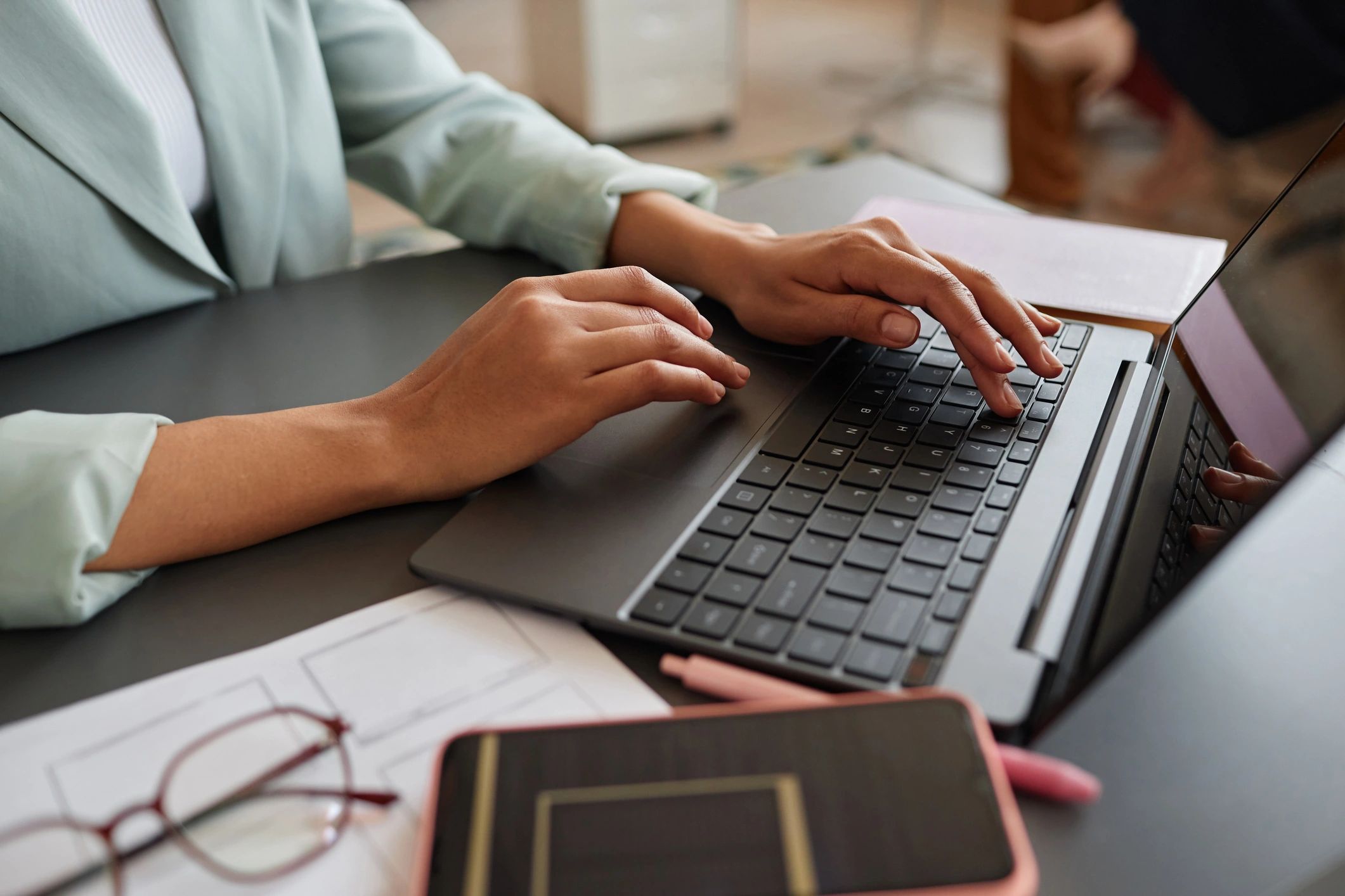 Professional working on a laptop in an office