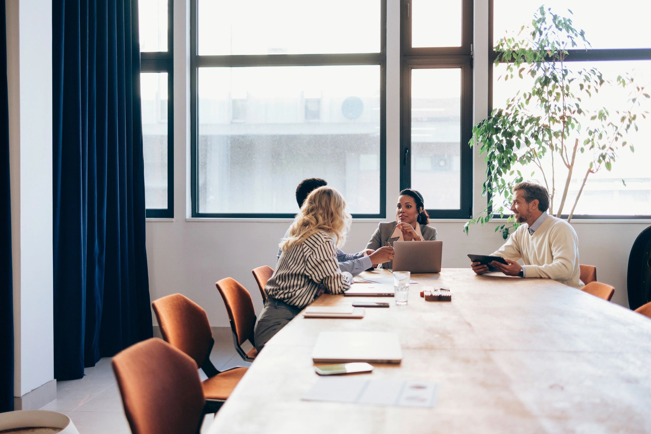 Team collaborating in a modern office meeting room