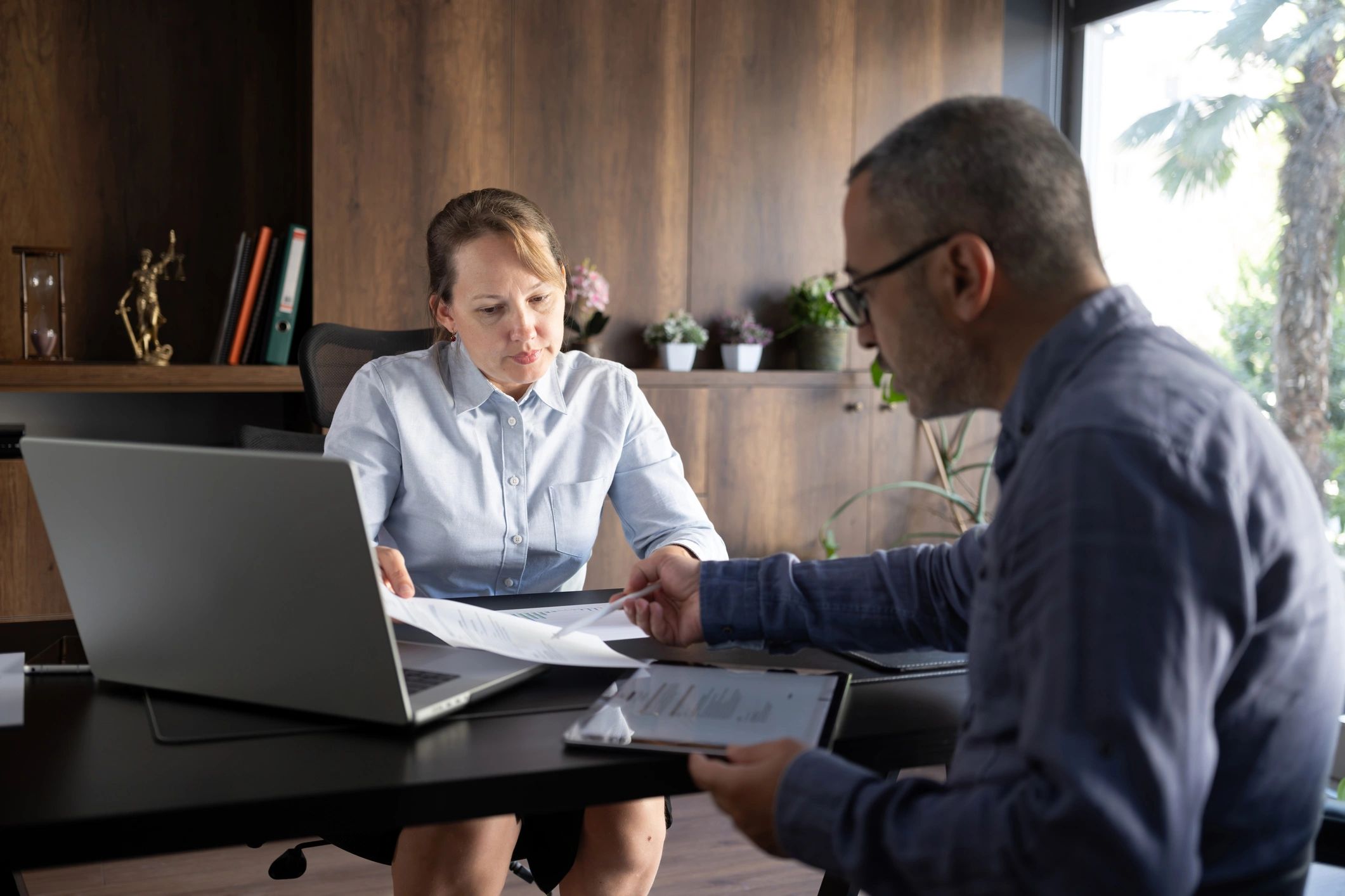 Business professionals reviewing project documents together